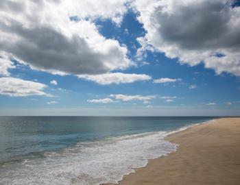 nantucket beach with sandy shore sunny skies and some clouds