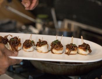 scallops on plate being served at a party