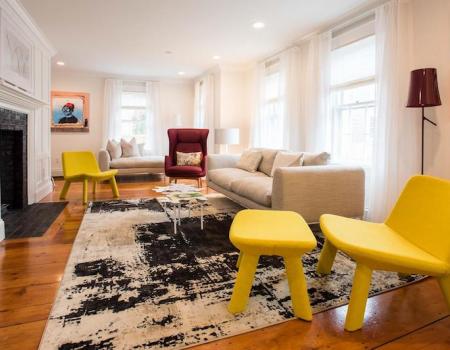 bright yellow chair, beige sofa and other bright furniture in background of bright modern living room