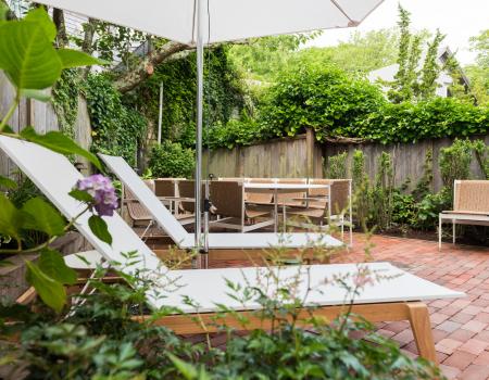 lounge chair in bright green foliage on sundeck at Nantucket vacation rental home