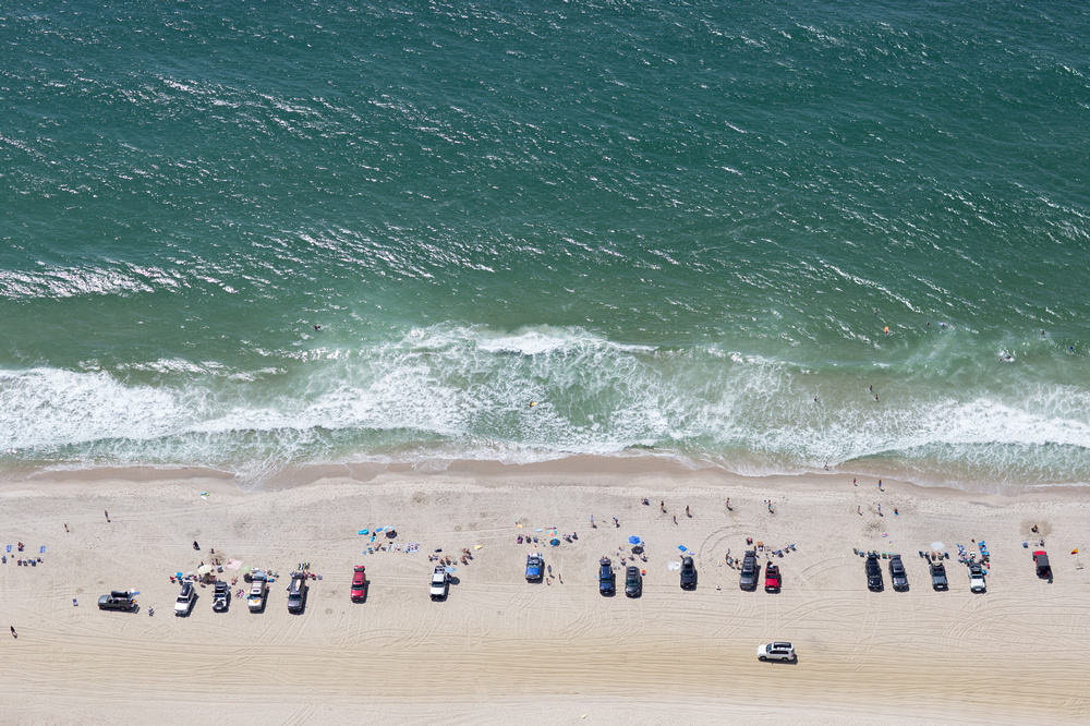 aerial view of nantucket beach with cars parked along the shoreline